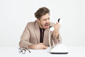 customer shouting on the phone (Photo by Icons8 Team on Unsplash)