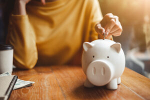 woman saving money in a piggy bank