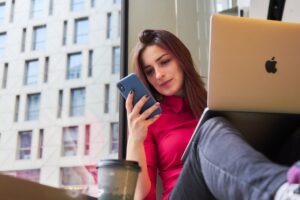 woman working from home using smartphone and laptop woman working from home using smartphone and laptop