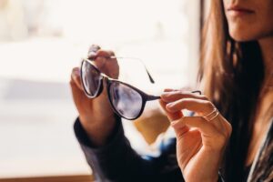 a lady holding stylish eyewear