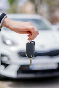 person holding a car key person holding a car key